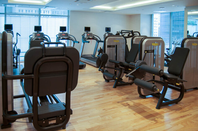 In-unit fitness room with treadmills, weight machines, and light hardwood floors. - 2702-667 Howe Street, Vancouver Downtown