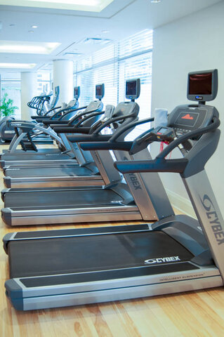 Spacious fitness room with hardwood floors and a row of treadmills facing bright. - 2702-667 Howe Street, Vancouver Downtown