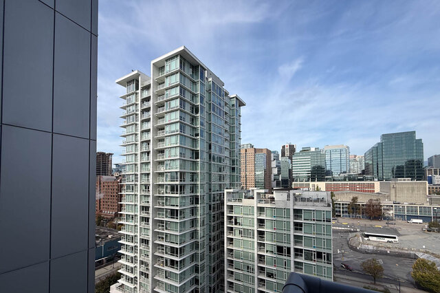 City view overlooking the downtown skyline with a glass high-rise and a bright blue sky. - 1603-668 Citadel Parade, Vancouver Downtown