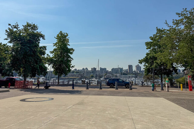 Open waterfront plaza with smooth concrete paving and a marina skyline framed by mature trees. - 1101-1067 Marinaside Crescent, Vancouver Downtown