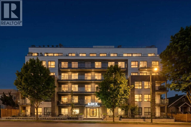 The six-storey LINX building at dusk, lit balconies on its tiered facade, the entrance sign over the front doors and mature t