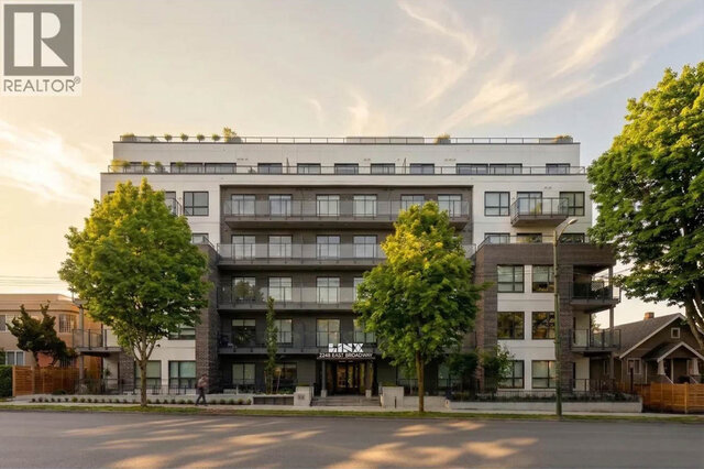 The LINX building at sunset, rows of glass-railed balconies, the entrance sign and street trees out front.