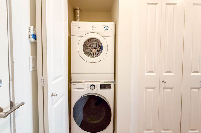 Stacked washer and dryer in a closet by the front door. - 302-1533 East 8th Avenue, Vancouver East Side