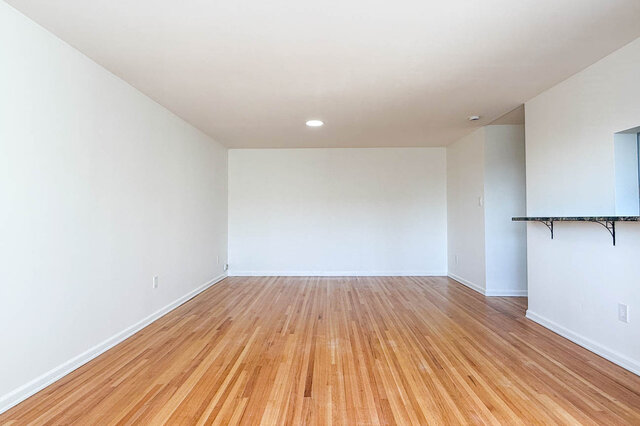 The dining end of the room beside the pass-through counter, on hardwood floors - 107-461-16th Street West, North Vancouver
