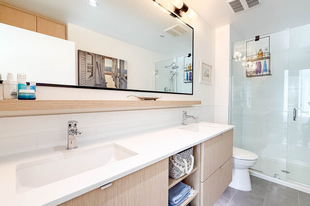 Ensuite with a double vanity and a walk-in glass shower. - 402-3205 Mountain Highway, North Vancouver