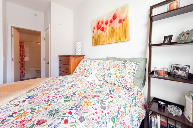 Second bedroom with the double bed and the door to its own ensuite bathroom. - 402-3205 Mountain Highway, North Vancouver