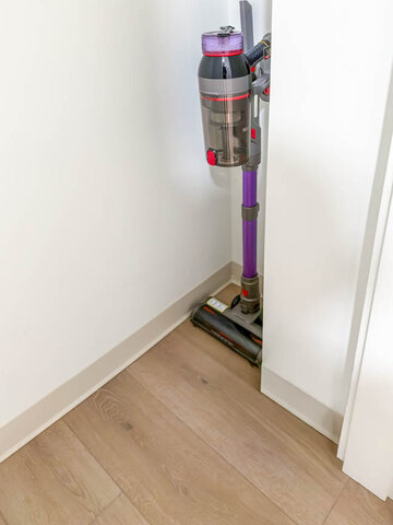 Cordless vacuum standing in a closet. - 611-1529 Oxford Street, North Vancouver