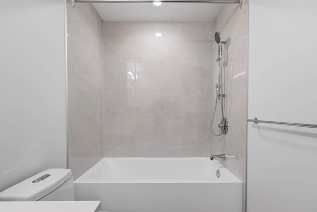 Tub and hand shower set in a tile surround. - 619-1529 Oxford Street, North Vancouver