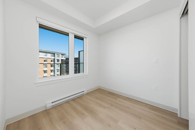Empty second bedroom with a big window and a sliding closet. - 424-1529 Oxford Street, North Vancouver