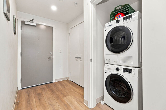 Entry hall with the front door, a double closet and a stacked washer and dryer in its own closet. - 224-1529 Oxford Street, North Vancouver