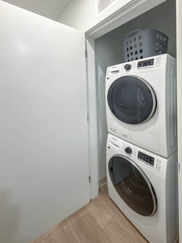 Stacked washer and dryer in their own closet. - 101-1529 Oxford Street, North Vancouver