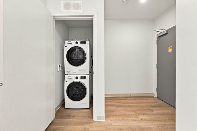 Stacked washer and dryer in a closet beside the front door. - 409-1529 Oxford Street, North Vancouver