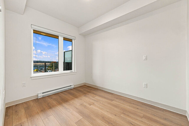 Bedroom with a window looking out to the balcony. - 409-1529 Oxford Street, North Vancouver