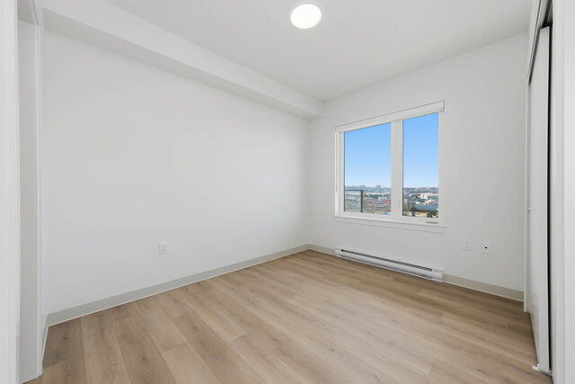 Second bedroom with a window on the balcony side and a sliding closet. - 518-1529 Oxford Street, North Vancouver