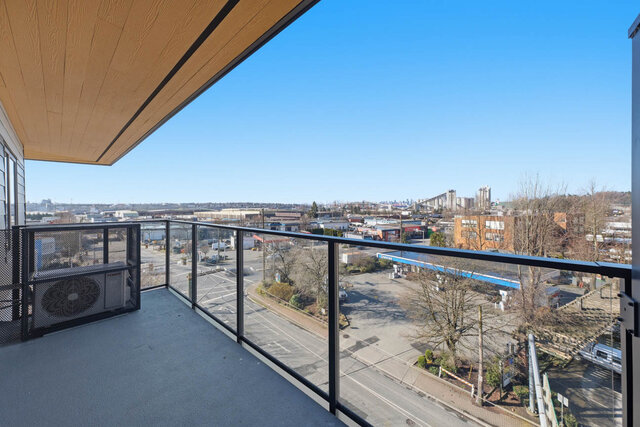 Covered balcony with a wood ceiling and glass railing, looking out over the street and neighbourhood. - 518-1529 Oxford Street, North Vancouver