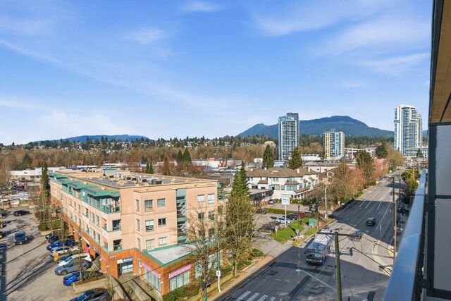 View from the balcony over the neighbourhood toward the North Shore mountains and nearby towers. - 518-1529 Oxford Street, North Vancouver