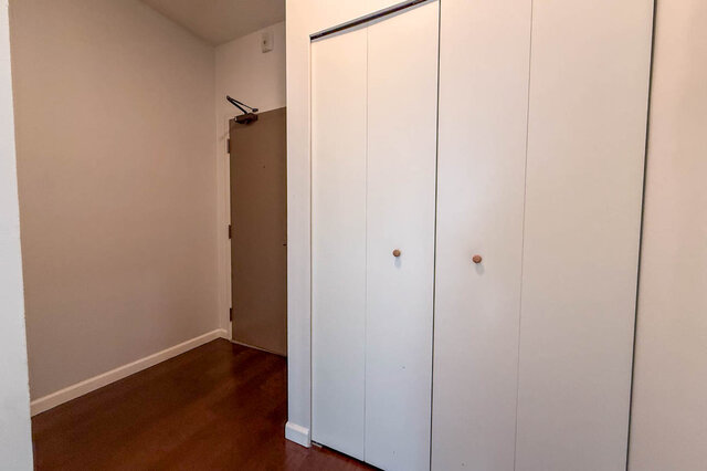 Entry inside the front door with a large double closet and hardwood floors. - 304-827 West 16th Street, North Vancouver