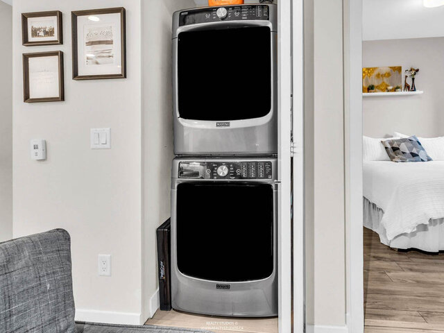 In-suite stacked washer and dryer in a closet off the living room, next to the bedroom. - 117-723 3rd street West, North Vancouver