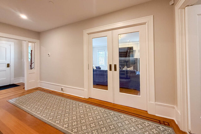 Glass pocket doors that close the living room off from the hall. - North Vancouver