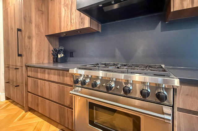 Close view of the professional range with gas burners. - North Vancouver