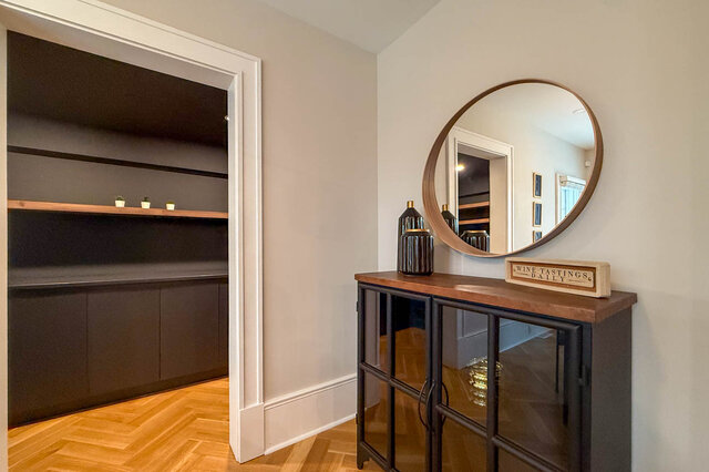 Built-in cabinet nook with a wood shelf, off the dining area. - North Vancouver