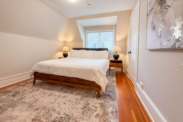 Second bedroom with a dormer window, sloped ceilings, a closet and hardwood floors. - North Vancouver