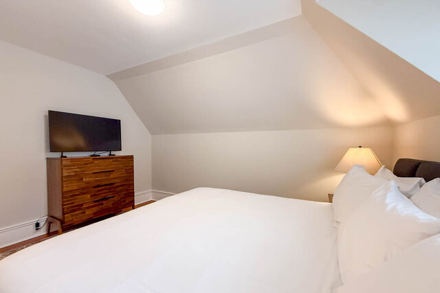 Second bedroom with sloped ceilings. - North Vancouver
